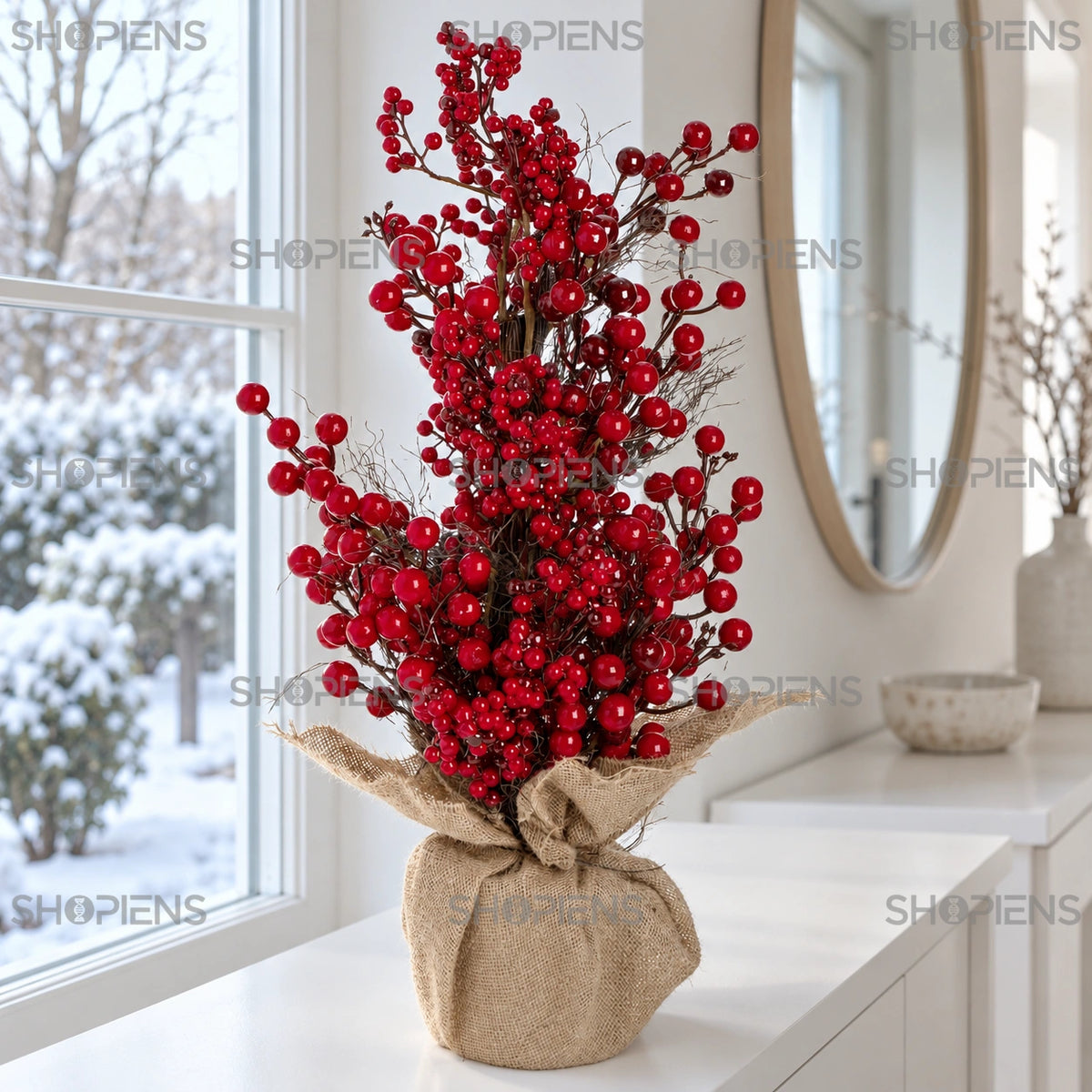 Brăduț decorativ cu fructe roșii pe bază din iută, 60 cm pe o consolă lângă fereastră, într-un decor de iarnă | Shopiens®