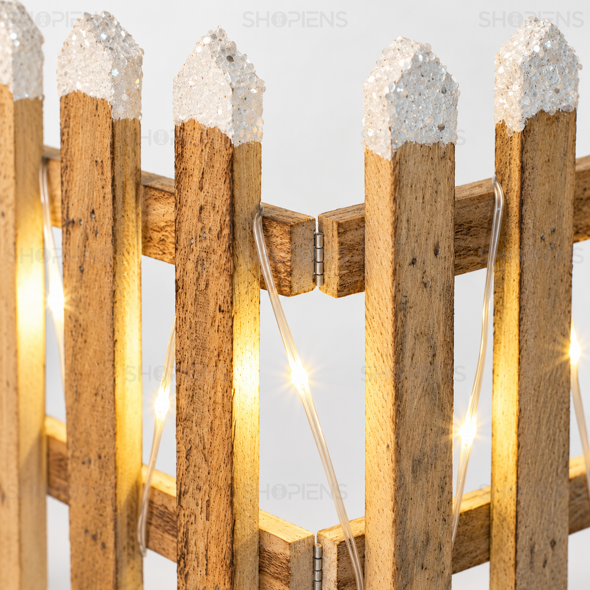 Detaliu al lemnului, vârfurilor ninse, balamalelor și LED-urilor aprinse ale gardului decorativ | Shopiens®
